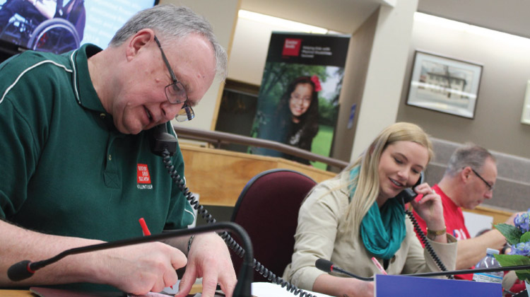 Volunteers take calls from donors at telethon.