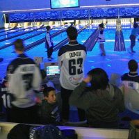 Sudbury wolves and friends at a bowling lane with blue lights.