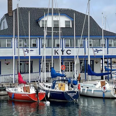 A row of boats docked in front of the KTC club house