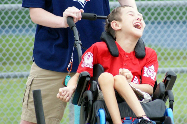 Maclain laughing and playing baseball