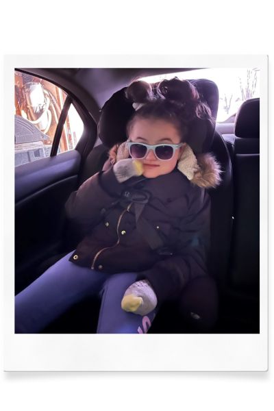 Image of Aspen in a car seat wearing sunglasses