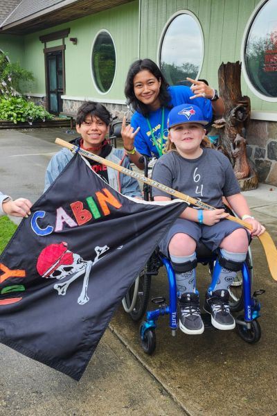 Nolan with camp staff and camper 