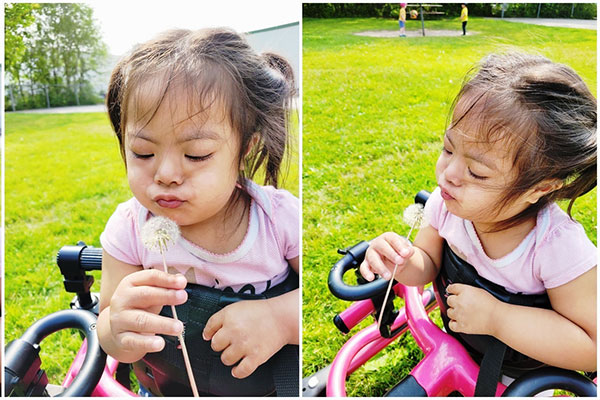 Ady blowing a dandelion.