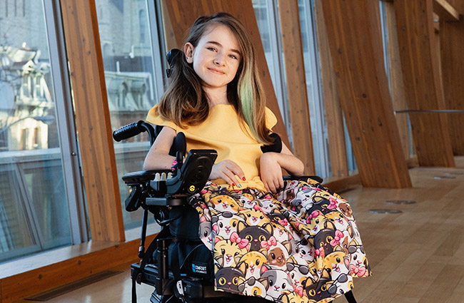 Chloe in a yellow shirt as ambassador.