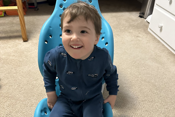 Wesley sitting with his device.